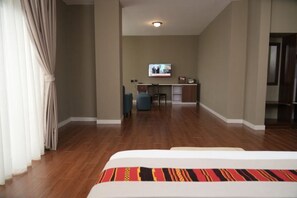 A hotel room with a bed, a desk, and a television in the background. - Haile Hotel Wolaita (Sodo)