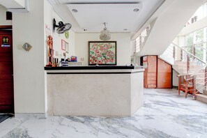 A spacious kitchen with a marble floor, a central island, and a staircase leading to an upper level. - Collection O Jalan Malioboro Near Lempuyangan Stat (Yogyakarta)