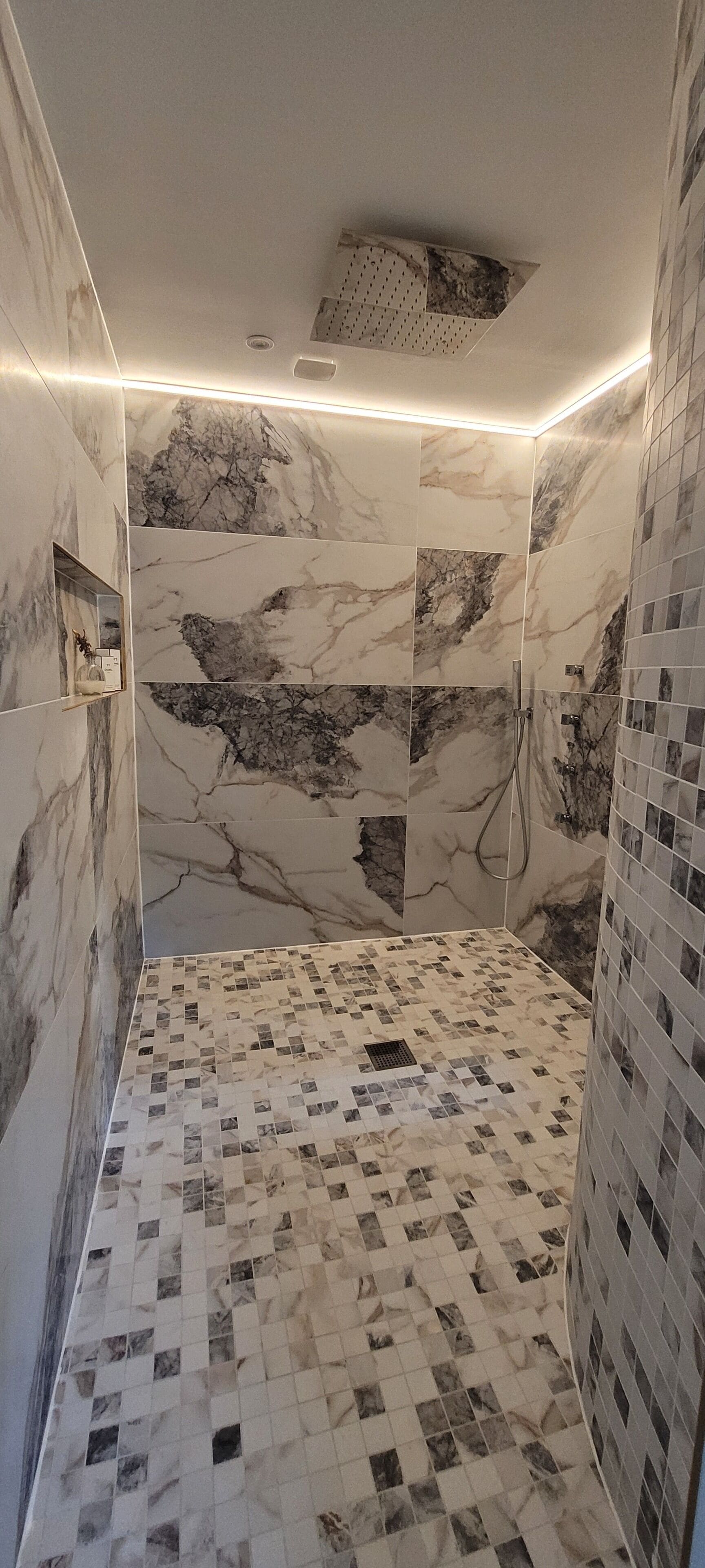 A bathroom with marble walls and a checkered floor.