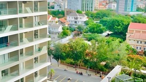 A multi-story building with balconies, a street with cars, and surrounding greenery. - 2 Bedroom Luxury Condotel - The Song Vung Tau (Vung Tau)