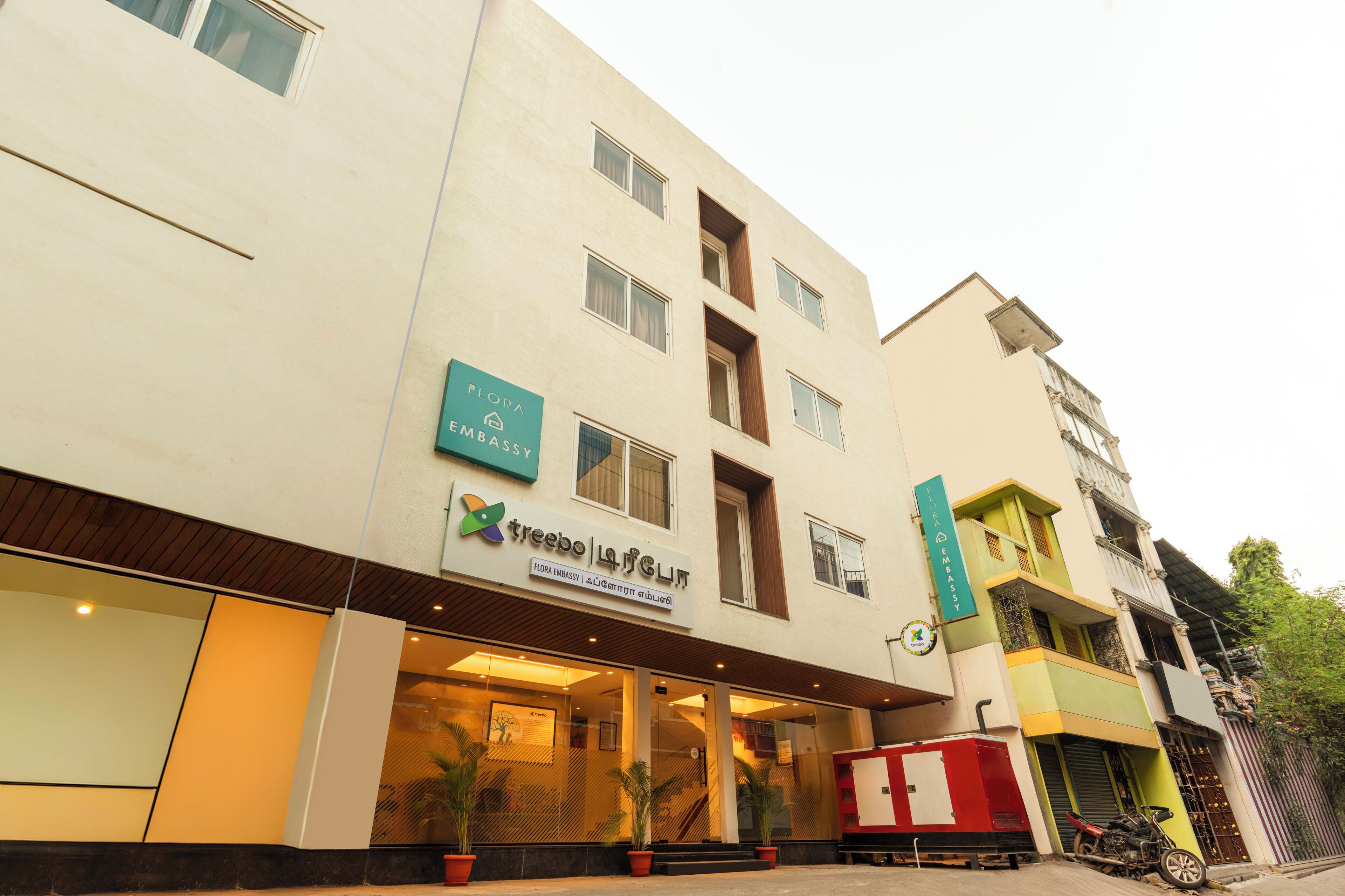 Un edificio con un letrero que dice 'treebo lounge' y 'flora embassy'.