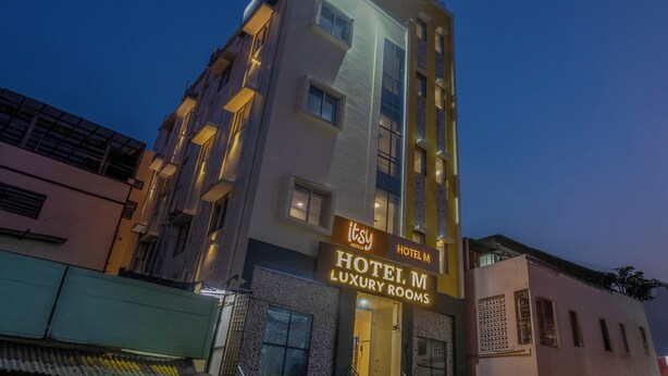 A multi-story building with a sign for 'Hotel M Luxury Rooms.' - Itsy Hotels M (Vijayawada)