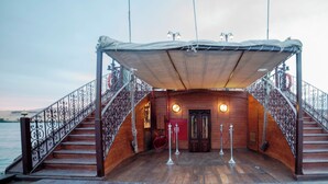 A wooden deck with a covered area, two staircases, and a railing. - Sonesta Dahabeya Amirat I - Nile Cruise Ship - 7 nights from Luxor every Saturday  (Luxor)