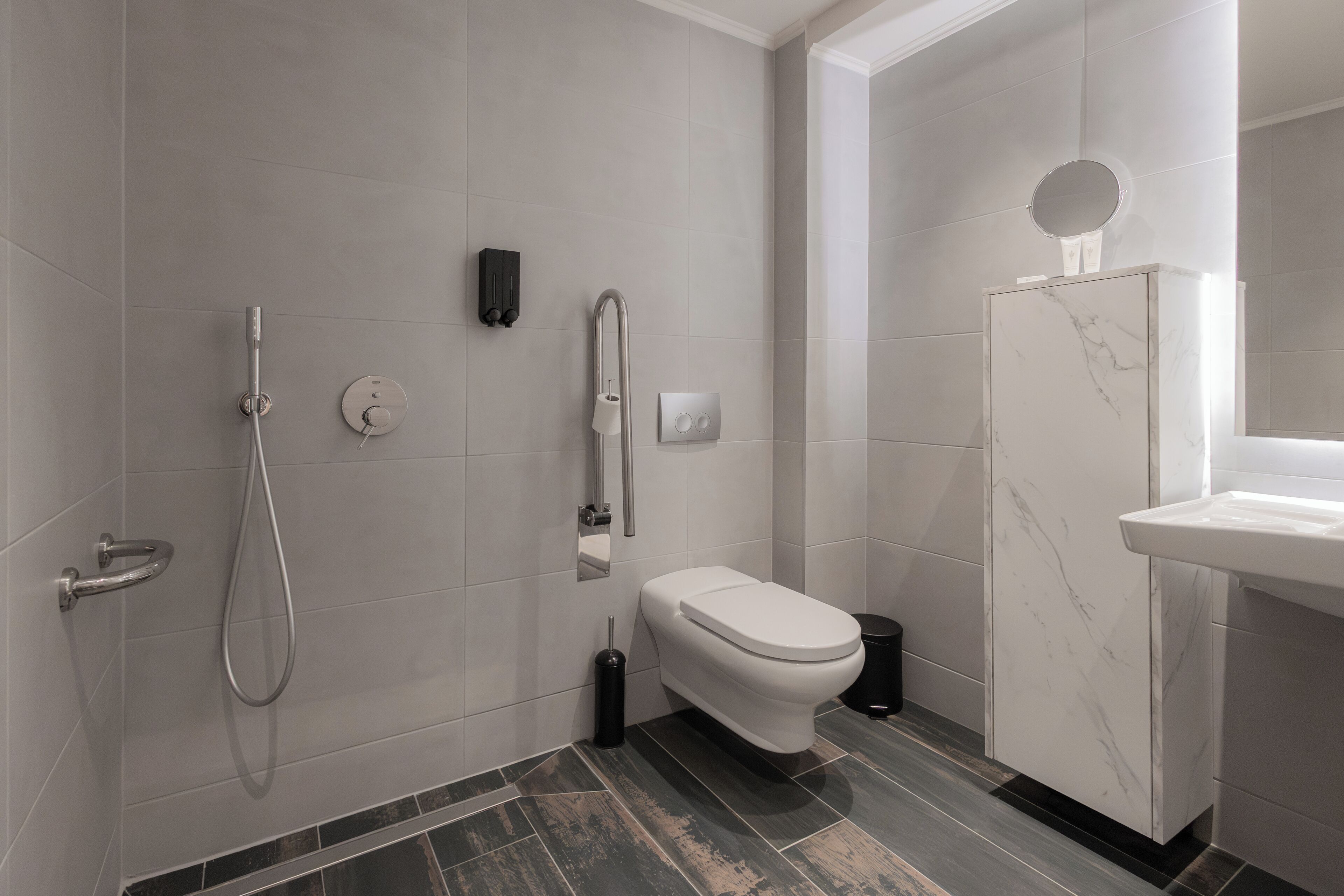 A modern bathroom with a shower, toilet, and vanity.