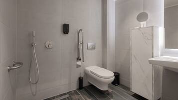 A modern bathroom with a shower, toilet, and vanity.