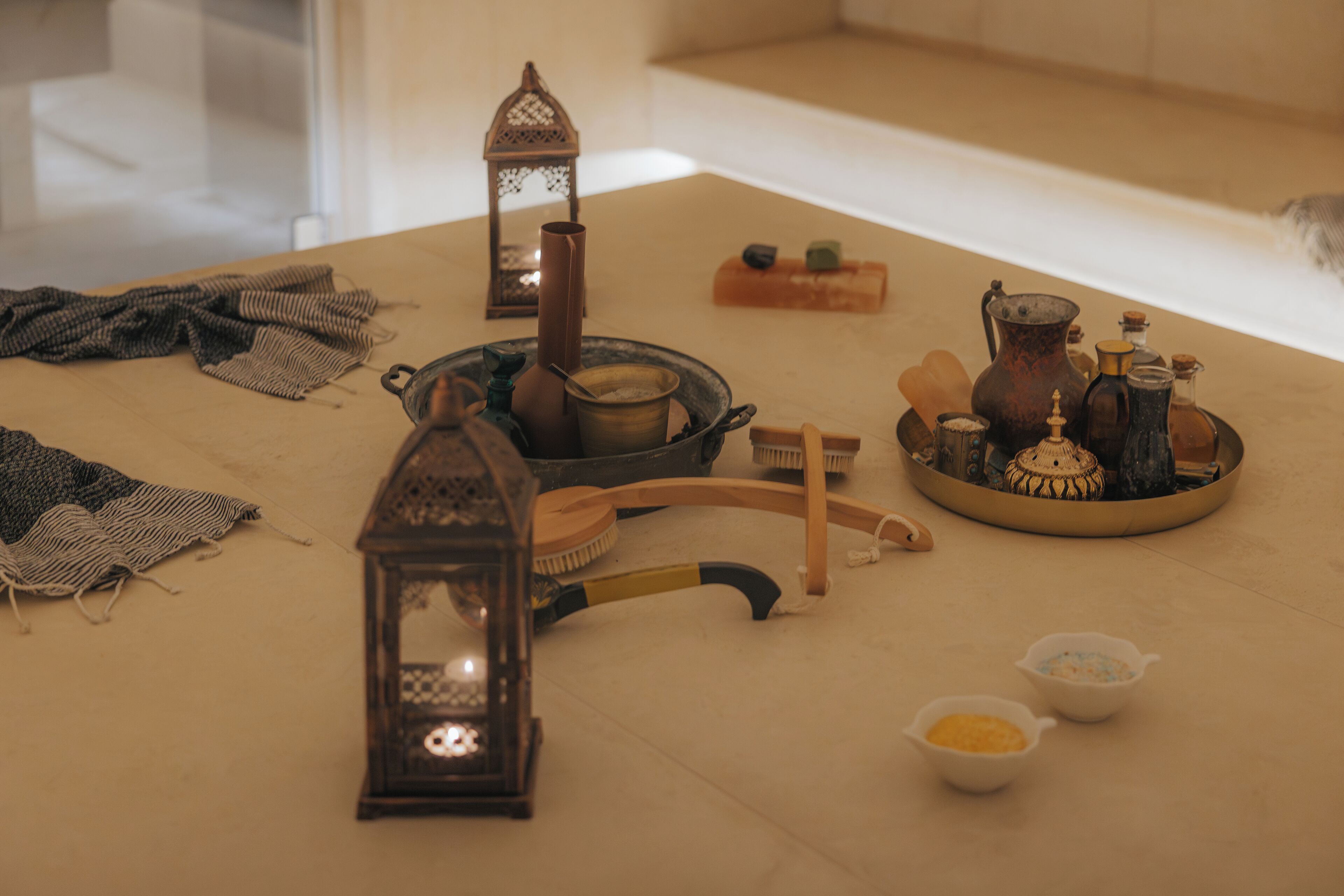 A table with various items including a lantern, brushes, and containers.