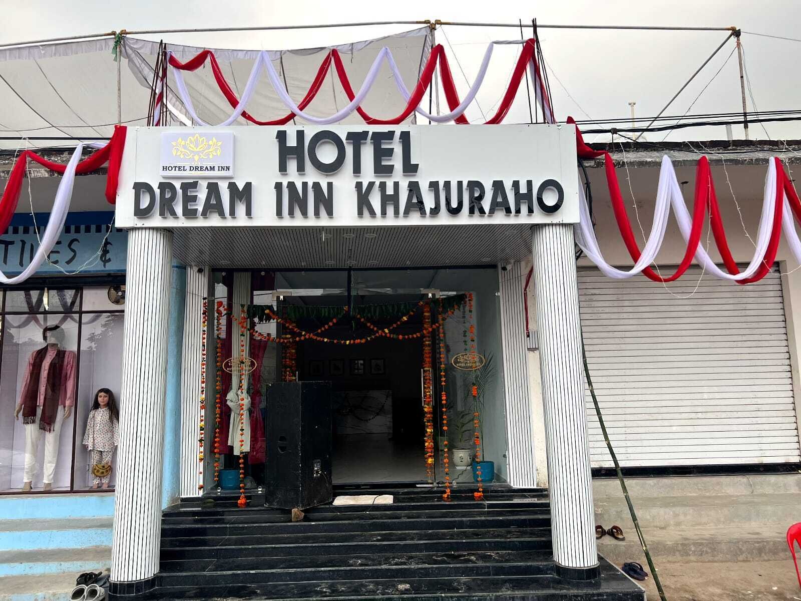 A hotel entrance with a sign reading 'HOTEL DREAM INN KHAJURAHO'.