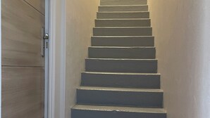 A staircase with a textured carpet at the bottom. - Gîte PREY DES VOSGES (Prey)