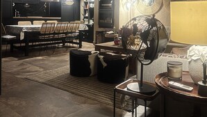 A modern kitchen with dark cabinetry, a dining area with a table and chairs, and a living area with a sofa and a fan. - Rural House La Real de Guadalupe (Guadalupe)