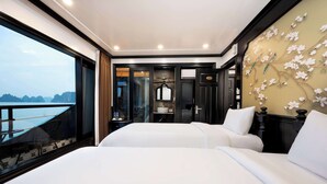 A hotel room with two beds, a large window with a view of the sea, and a decorative wall with floral patterns. - Dragon Premium Cruise (Tuan Chau)