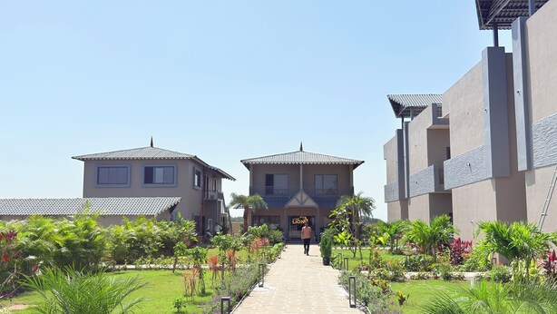 A pathway leading to a building with a sign reading "Gold Lion". - Gold Lion Resort (Talala)