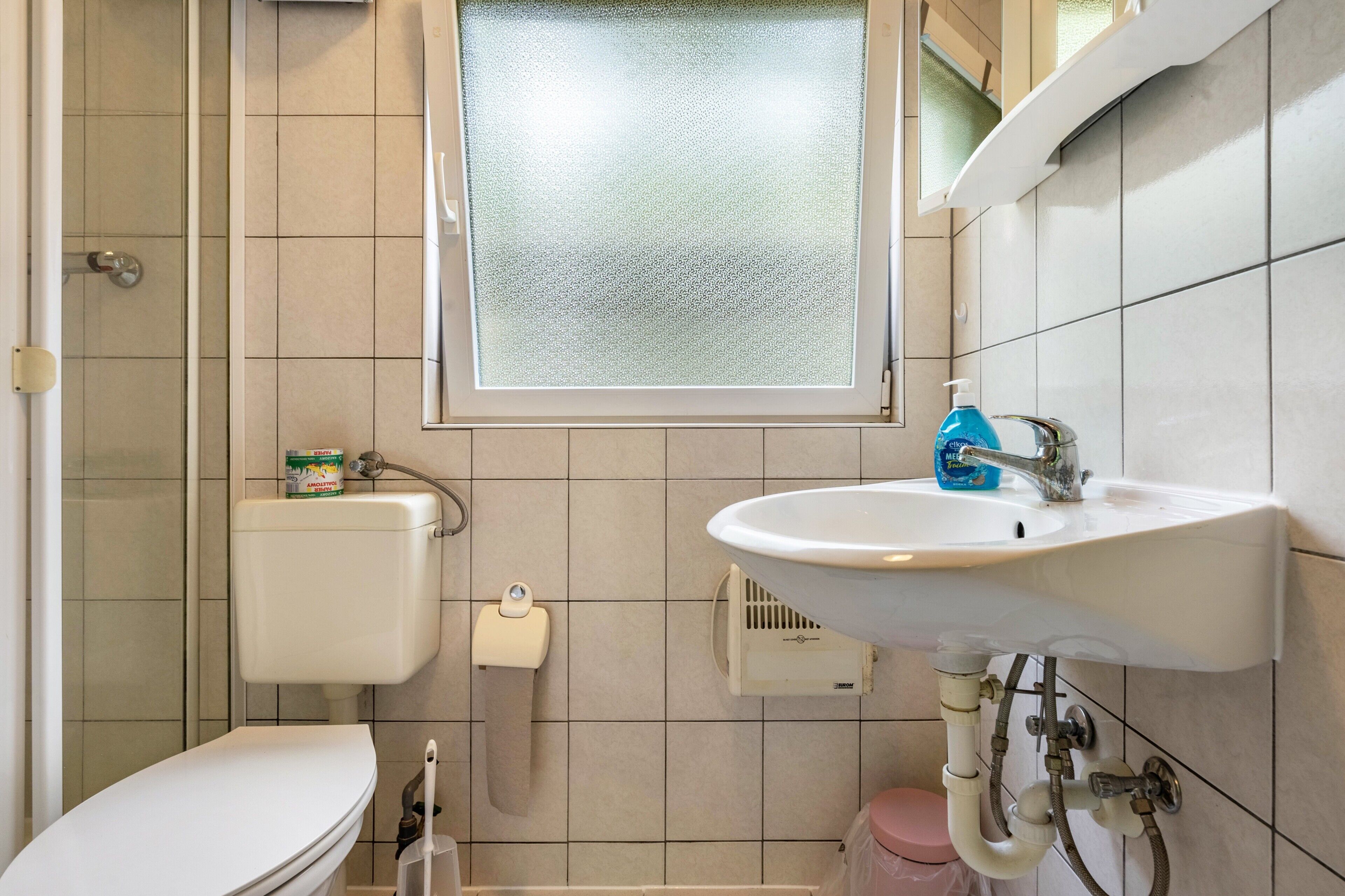 Un bagno con WC, lavandino e doccia.