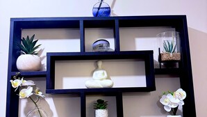 A wall-mounted shelf with multiple compartments containing various decorative items. - Superb 2-bedroom apartment in Preston (Preston)