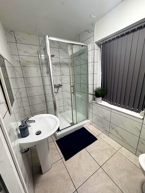 Shower, towels, soap, toilet paper