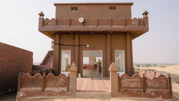 A two-story building with a balcony and a covered entrance. - Bhati Desert Camp Raisar Bikaner (Bikaner)