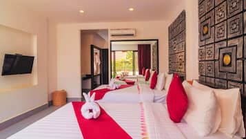 A hotel room with two beds, a flat-screen TV, a wall-mounted air conditioner, and a decorative wall panel.