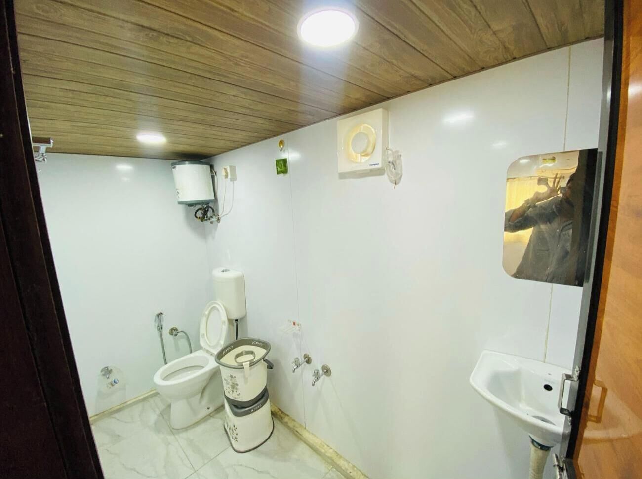 A small, compact bathroom with a toilet, bidet, and sink.