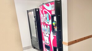 A vending machine with a colorful design, a door, and a sign indicating it accepts credit and debit cards. - 2037 | Upscale 2Q Near Park City + Pool/Hot Tub (Midway)