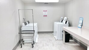 A laundry room with a cart, washing machines, and a sign on the wall. - 2037 | Upscale 2Q Near Park City + Pool/Hot Tub (Midway)