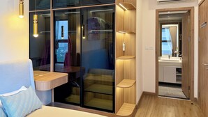 A modern bedroom with a built-in wardrobe, a bedside table, and a large window. - Armin Homes Corner 3 BRs with bathtub (Phung Cong)