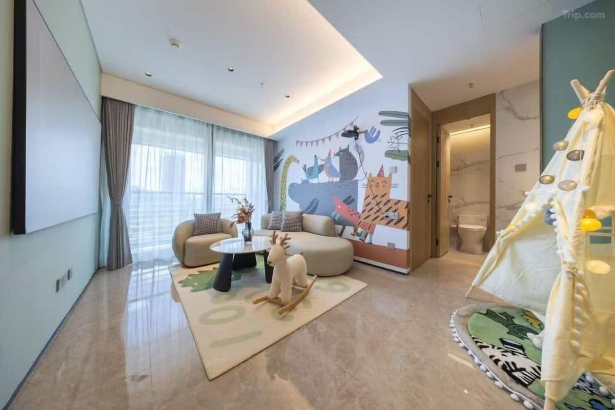A modern living room with a sofa, coffee table, and a decorative reindeer sculpture.