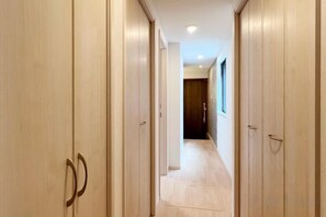 A hallway with wooden doors and a tiled floor. - Oku Station;4 Minutes Walk from Station;Ueno 5 Minutes; Tokyo 12Minutes; Shinbashi (Ginza) 15Minutes (Tokyo)