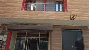 A multi-story building with a modern design, featuring balconies and a central entrance with steps. - Roomshala Hotel Pub G (New Delhi)