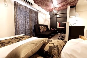 A hotel room with a bed, a sofa, a desk, and a chair. - Ra Premier K (Osaka)