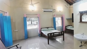 A bedroom with a bed, a chair, a sink, and a window. - Little Yellow House • Insta: @little.yellow.house1943 (Cansaulim)