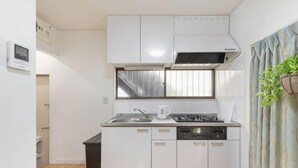 A compact kitchen with white cabinets, a sink, a stove, and a dishwasher. - 2/6/MAX4/Nakanoshinbashi (Tokyo)