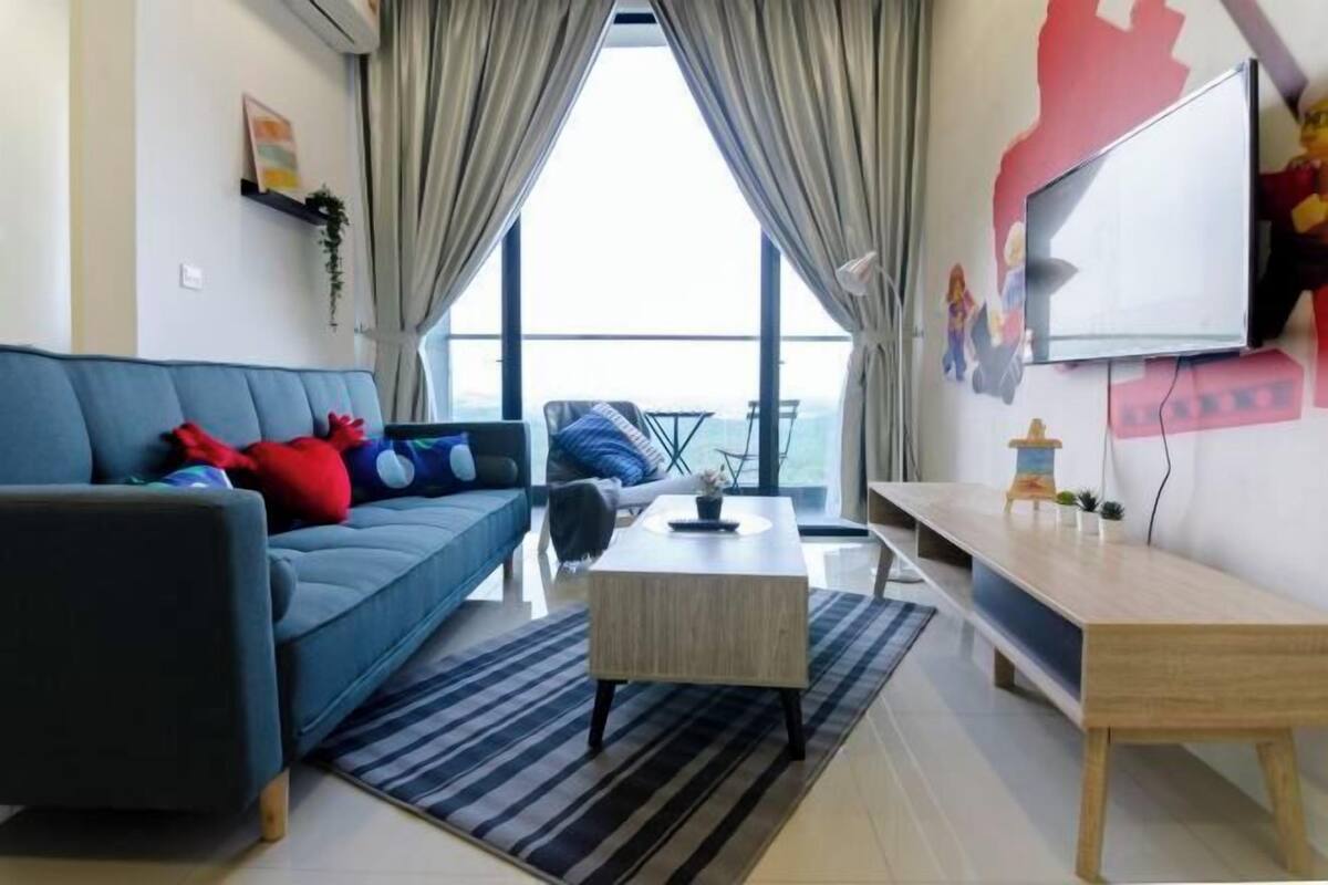 A modern living room with a sofa, coffee table, and TV.