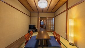 A traditional Japanese-style room with tatami flooring, a low table, and sliding doors. - Nijo Ohan (Kyoto)