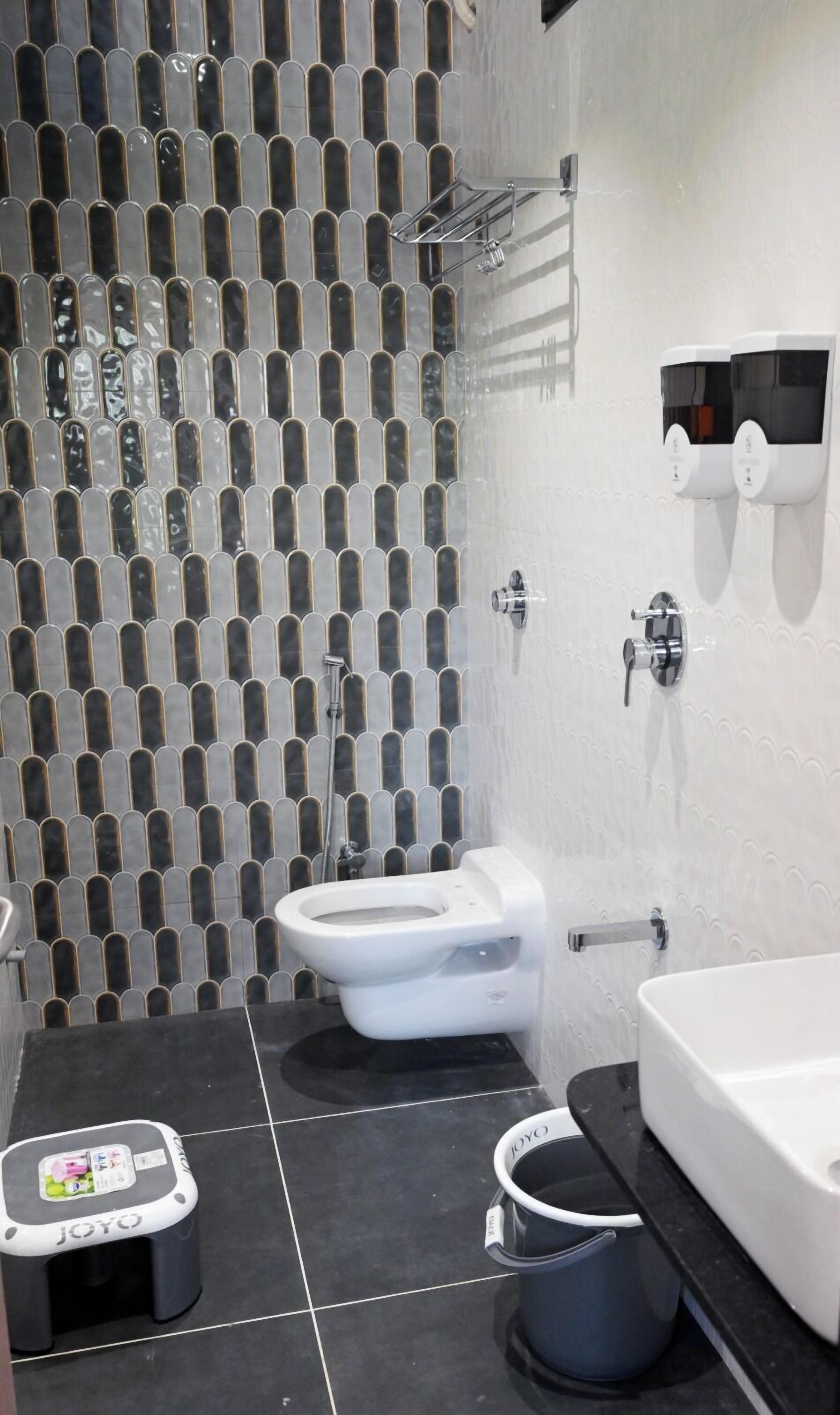 A modern bathroom with a toilet, bidet, and sink.