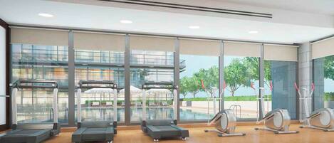Un gimnasio con cintas de correr, máquinas elípticas y un ventanal con vistas a árboles y edificios.