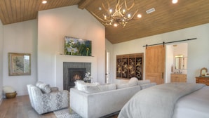 A spacious living area with a fireplace, sofas, and a large bed. - Brand New Home on 2 Acres - Amazing Deck/Views - Hot Tub/BBQ/Fire Table/AC (Durango)