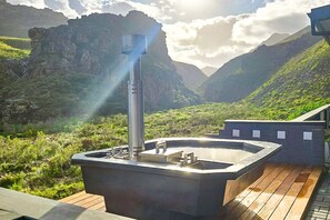 A hot tub on a wooden deck with a mountainous backdrop. - Red River Valley (Rooiels)