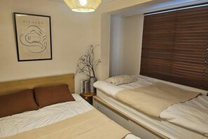 A hotel room with two beds, a framed artwork on the wall, and a window with blinds. - Yongsan, HYBE, Myeongdong, Gwangjang Market, Gyeongbokgung Palace, Luggage Storage Service 8 people (Seoul)