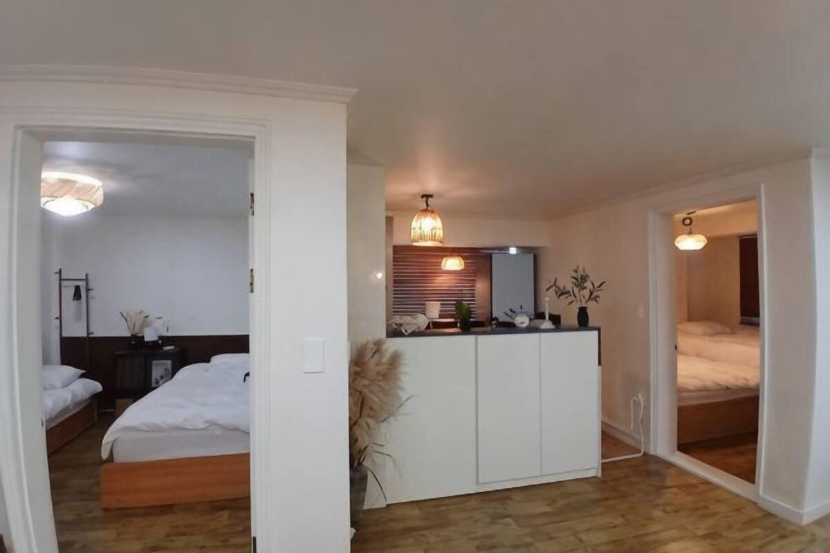 A bedroom with a bed, a bedside table, and a wardrobe.