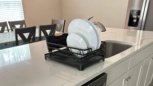 A kitchen with a dishwasher, a dish rack, and a sink. - Relax near Historic St. Augustine & Beaches (St. Augustine)