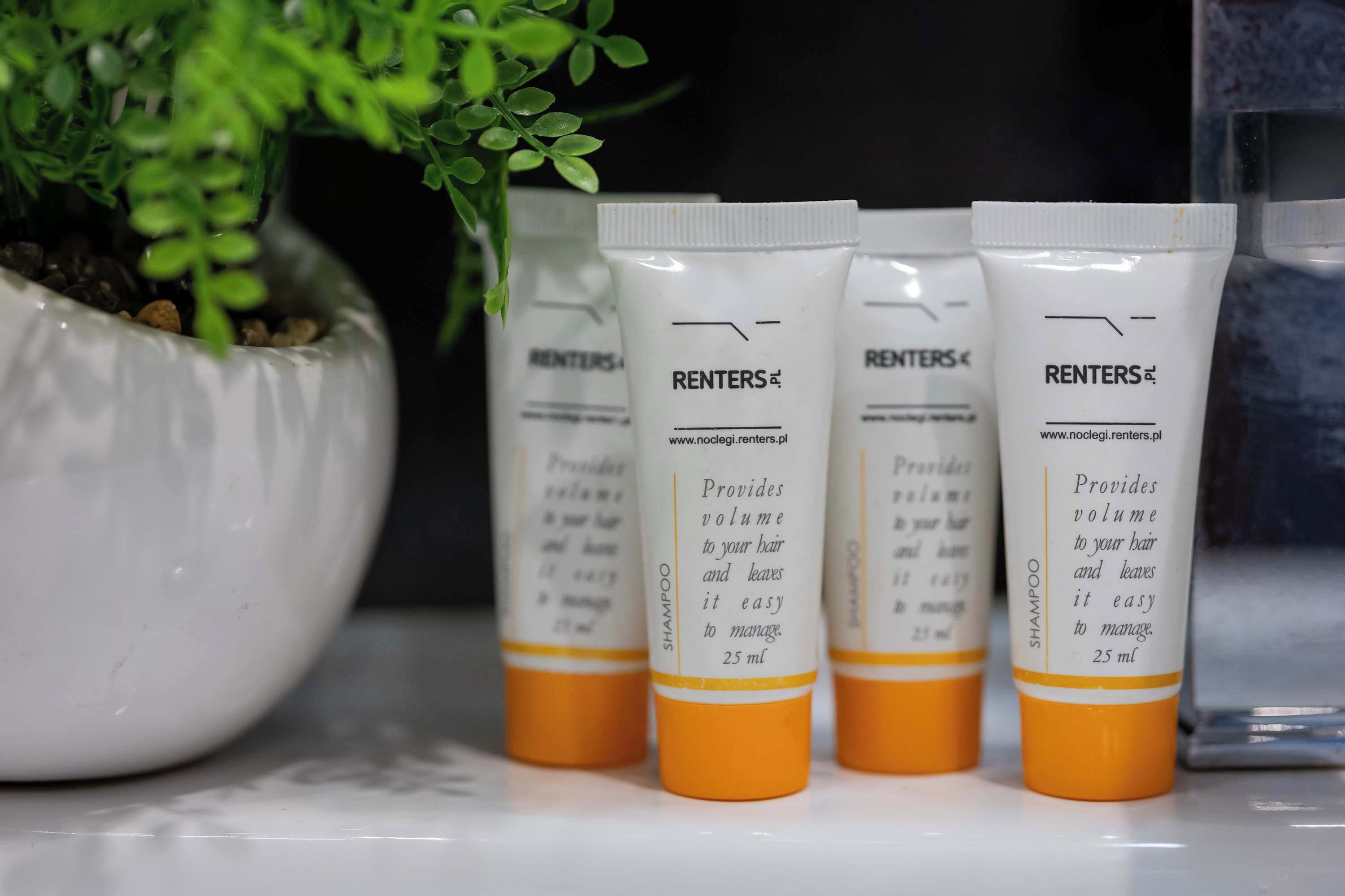 Four bottles of RENTERS® shampoo on a shelf.