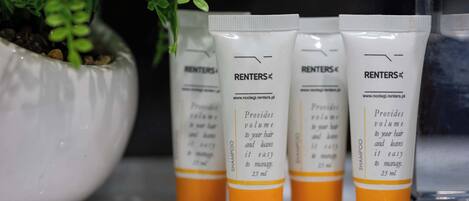 Four bottles of RENTERS® shampoo on a shelf.