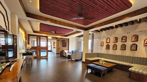 A spacious lobby with a high ceiling, a central seating area, and a reception desk. - Azydo, Art House, Grand Road, Near Jagannath Mandir (Puri)