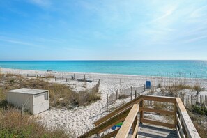 A beach with a wooden boardwalk, sandy beach, and a fenced area. - Crystal Villas B9 New Listing Specials! Gulf Front, Pool, Free Beach Service (Destin)