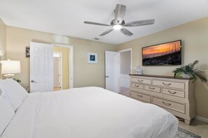 A bedroom with a bed, a dresser, a ceiling fan, and a painting on the wall. - Crystal Villas B9 New Listing Specials! Gulf Front, Pool, Free Beach Service (Destin)