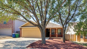 A residential house with a garage, a driveway, and a tree in front. - San Antonio Area Home w/ Deck, 14 Mi to Dtwn! (San Antonio)