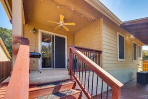 A wooden deck with a ceiling fan, a barbecue grill, and a sliding glass door leading to a covered porch. - San Antonio Area Home w/ Deck, 14 Mi to Dtwn! (San Antonio)