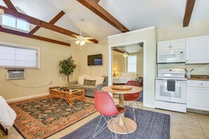 A spacious living area with a large rug, a dining table with chairs, a sofa, and a kitchen with white cabinets and appliances. - Walkable Studio 1 Mi to Riverwalk & Dtwn Bradenton (Bradenton)