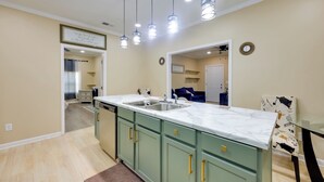 A kitchen with a marble countertop, green cabinets, and pendant lights. - < 10 Mi to Uab: Birmingham Group Getaway (Birmingham)