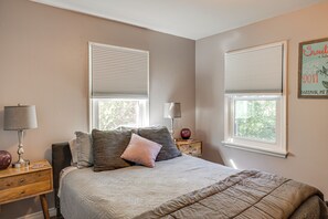 A bedroom with a bed, two nightstands, lamps, and two windows with blinds. - Fishing & Skiing Base! Residential Bozeman Escape (Bozeman)