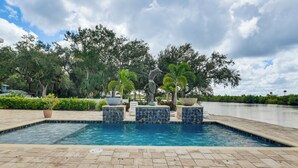 A swimming pool with tiled edges, surrounded by a paved deck and potted plants. - Waterfront Arcadia Home w/ Dock on Peace River (Fort Ogden)